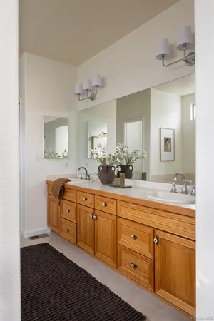 a spacious bathroom with double sink large mirror and