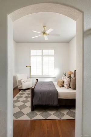 a bedroom with a bed couch and window