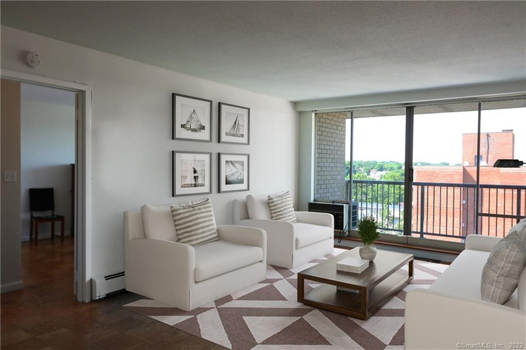 65 Glenbrook Road, Unit 9G Stamford, CT 06902 - Photo 1 of 1 a living room with furniture and a floor to ceiling window