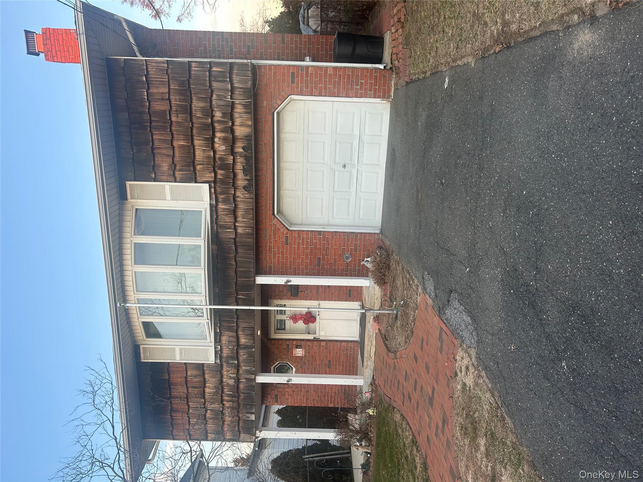 131 Ethel Street Valley Stream, NY 11580 - Photo 3 of 18 a front view of a house with a yard and garage