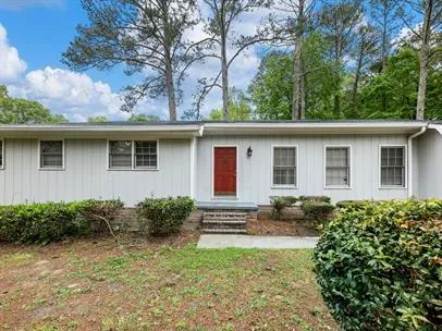 a house with trees in the background