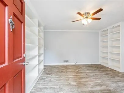 a view of a room with wooden floor and closet