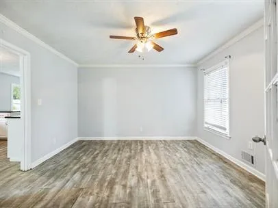wooden floor in an empty room with a window