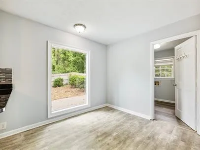 an empty room with windows and closet