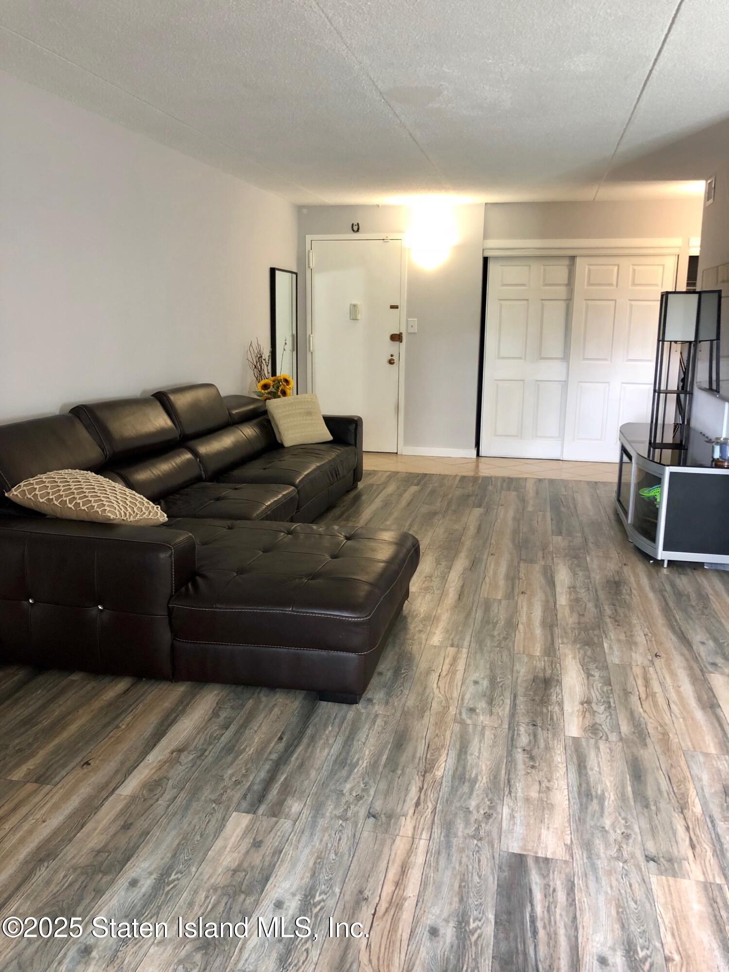 11 Windham Loop, Unit 2DD Staten Island, NY 10314 - Photo 14 of 27 a living room with furniture and a wooden floor