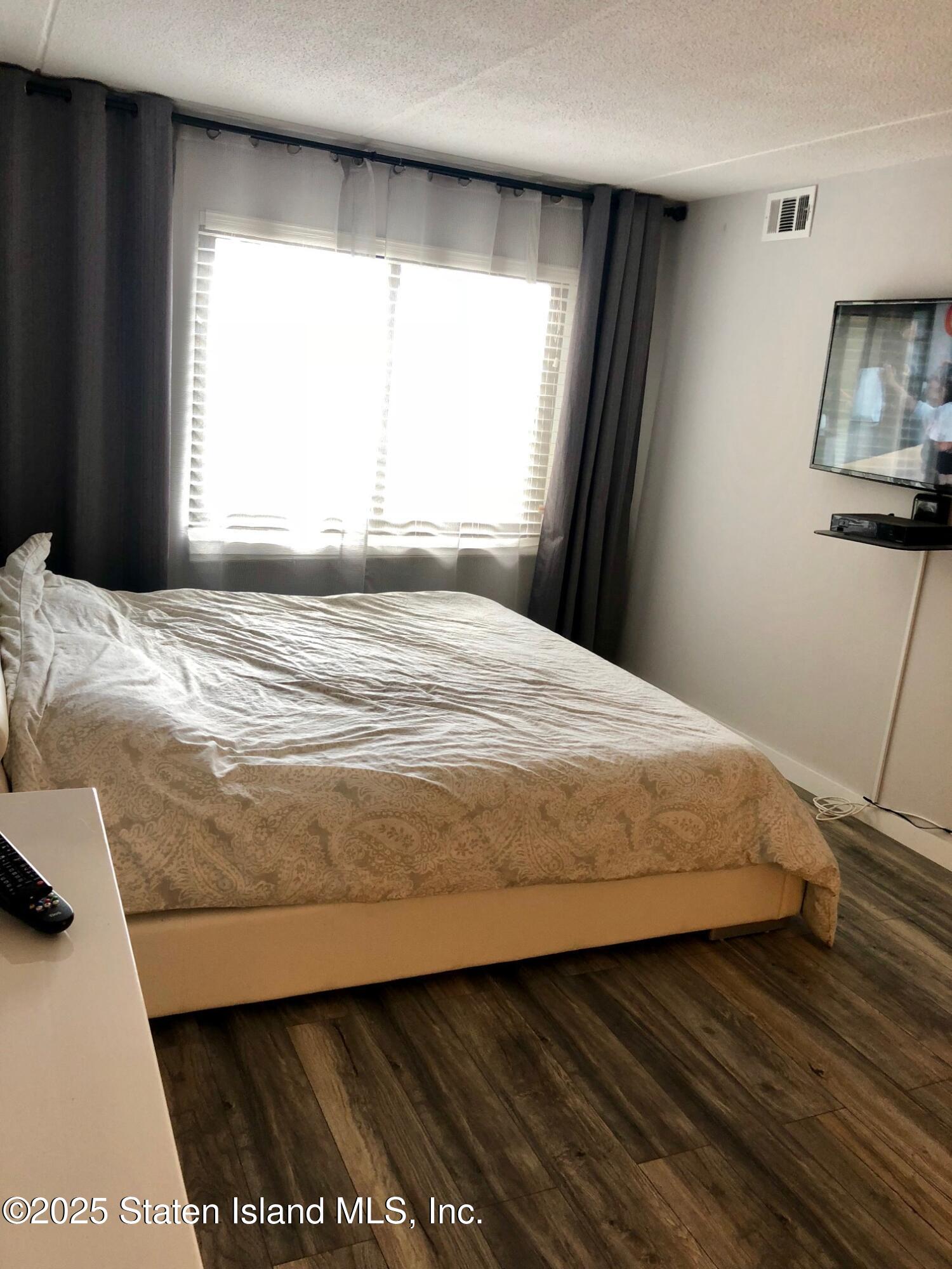 11 Windham Loop, Unit 2DD Staten Island, NY 10314 - Photo 16 of 27 a bedroom with a bed and a window