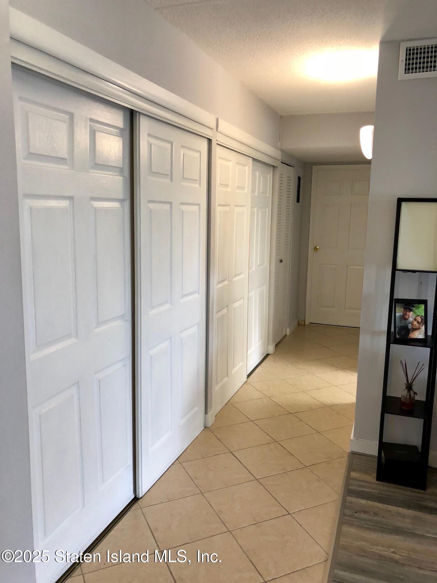 11 Windham Loop, Unit 2DD Staten Island, NY 10314 - Photo 18 of 27 a view of entryway with stairs and furniture