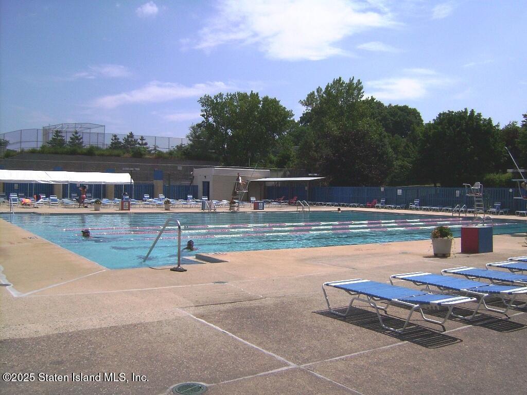 11 Windham Loop, Unit 2DD Staten Island, NY 10314 - Photo 23 of 27 a swimming pool with outdoor seating and city view