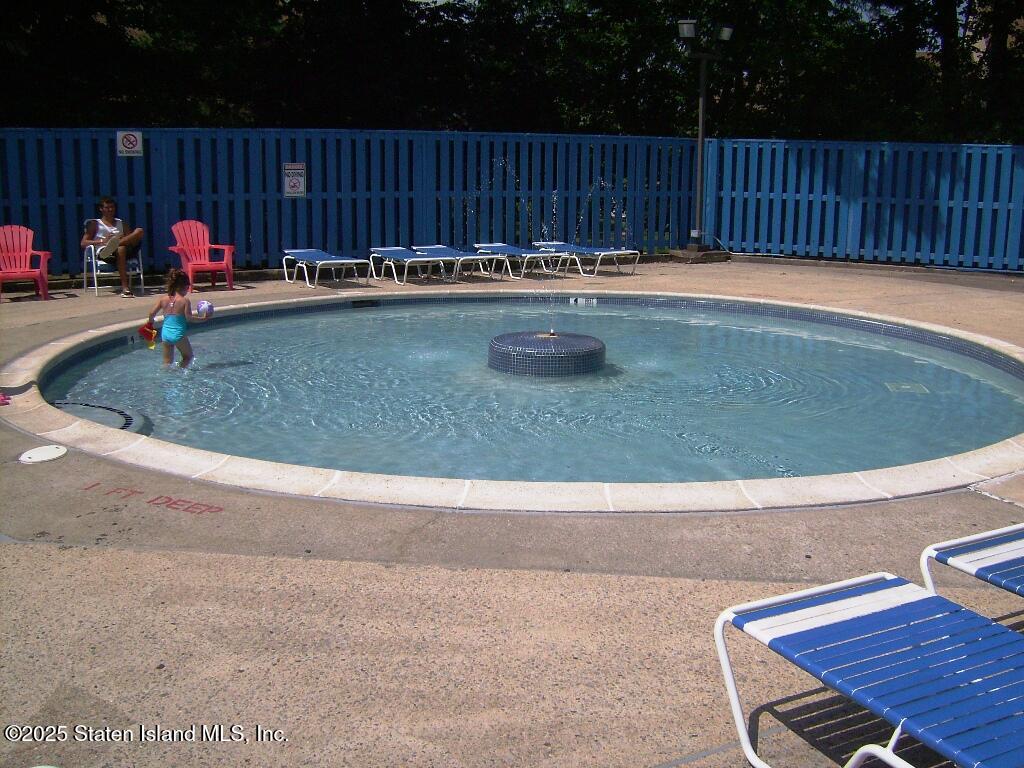 11 Windham Loop, Unit 2DD Staten Island, NY 10314 - Photo 25 of 27 a swimming pool with wooden fence