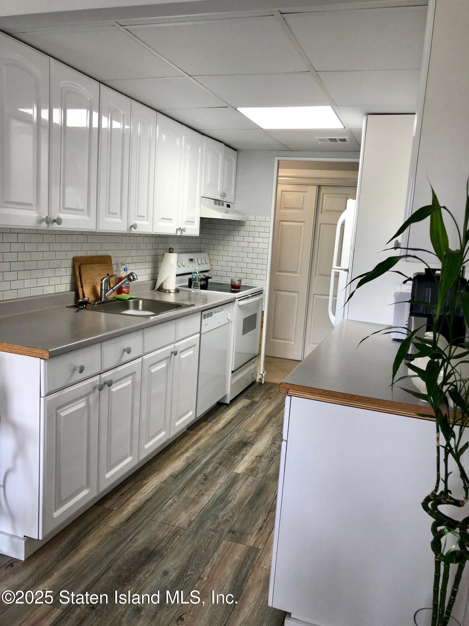 11 Windham Loop, Unit 2DD Staten Island, NY 10314 - Photo 10 of 27 a kitchen with stainless steel appliances granite countertop a sink a stove a refrigerator and cabinets