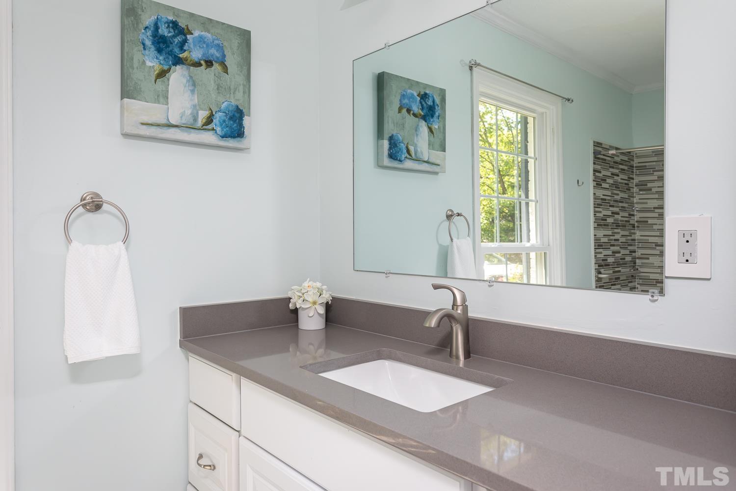 1304 Lake Pine Drive Cary, NC 27511 - Photo 11 of 26 a bathroom with a granite countertop sink and a window