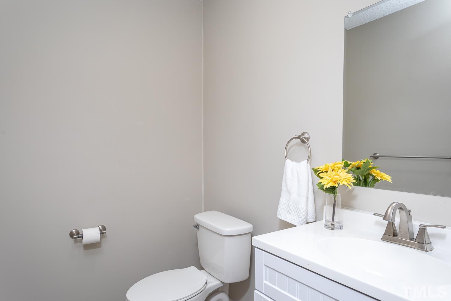 1304 Lake Pine Drive Cary, NC 27511 - Photo 13 of 26 a bathroom with a sink mirror vanity and toilet