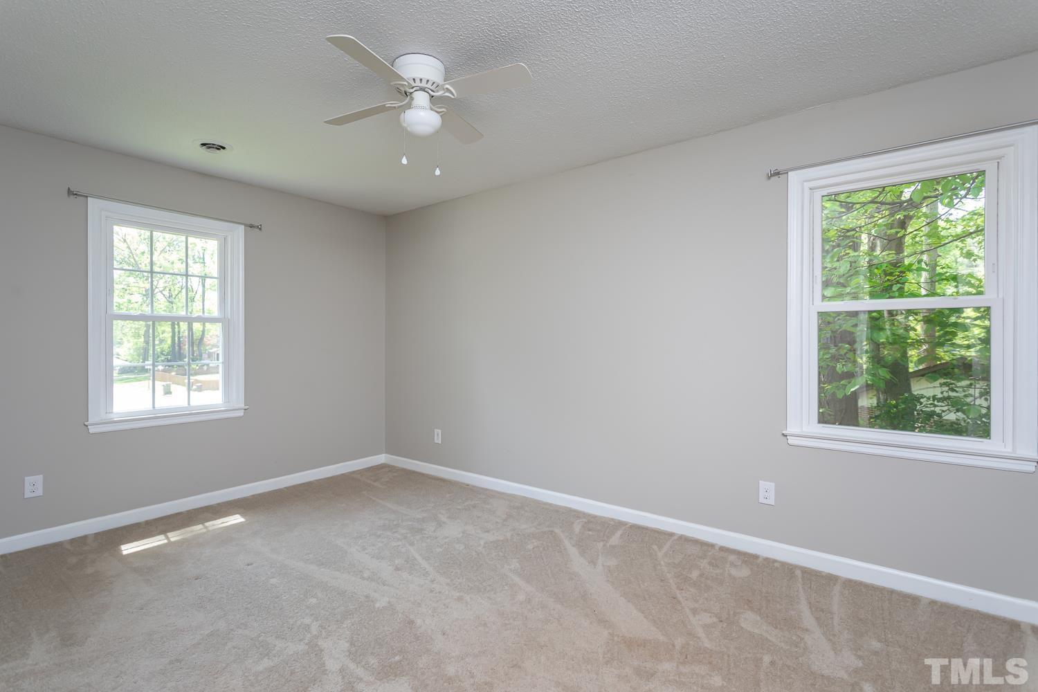 1304 Lake Pine Drive Cary, NC 27511 - Photo 16 of 26 an empty room with a window and a fan