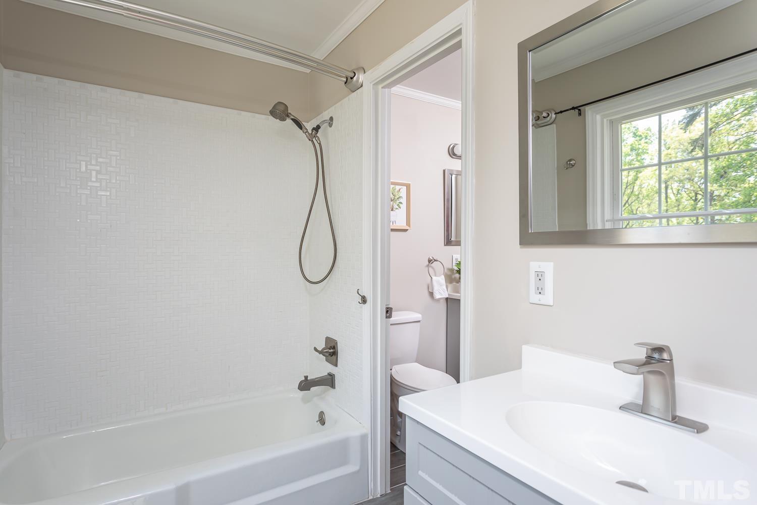 1304 Lake Pine Drive Cary, NC 27511 - Photo 19 of 26 a bathroom with a granite countertop sink a toilet and shower