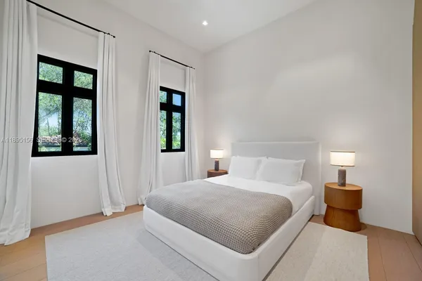 an aerial view of a house with a garden and lake view