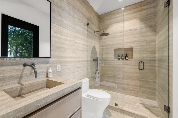 an aerial view of a house with a yard and garden