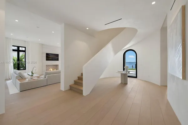 a very nice looking dining room with a large kitchen island a stove and a refrigerator