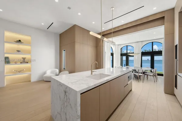 a living room with fireplace furniture and a large window