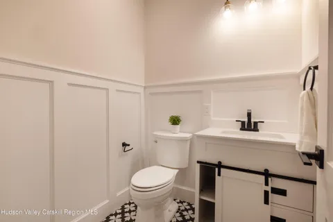 a bathroom with a sink a toilet and vanity
