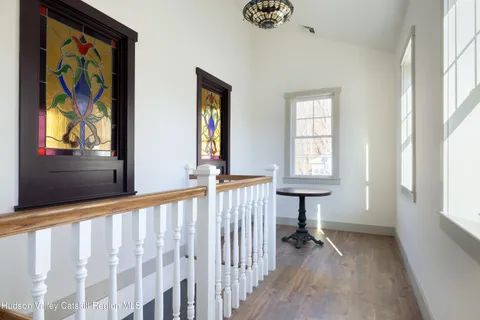 a bathroom with a toilet a sink a window and mirror