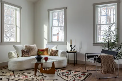 a view of a house with a small yard and wooden fence