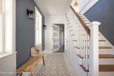 a view of an entryway with wooden floor and a window