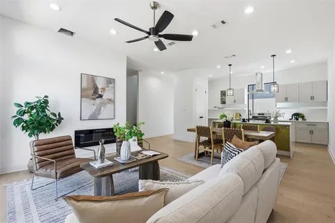 a living room with furniture plant and a window