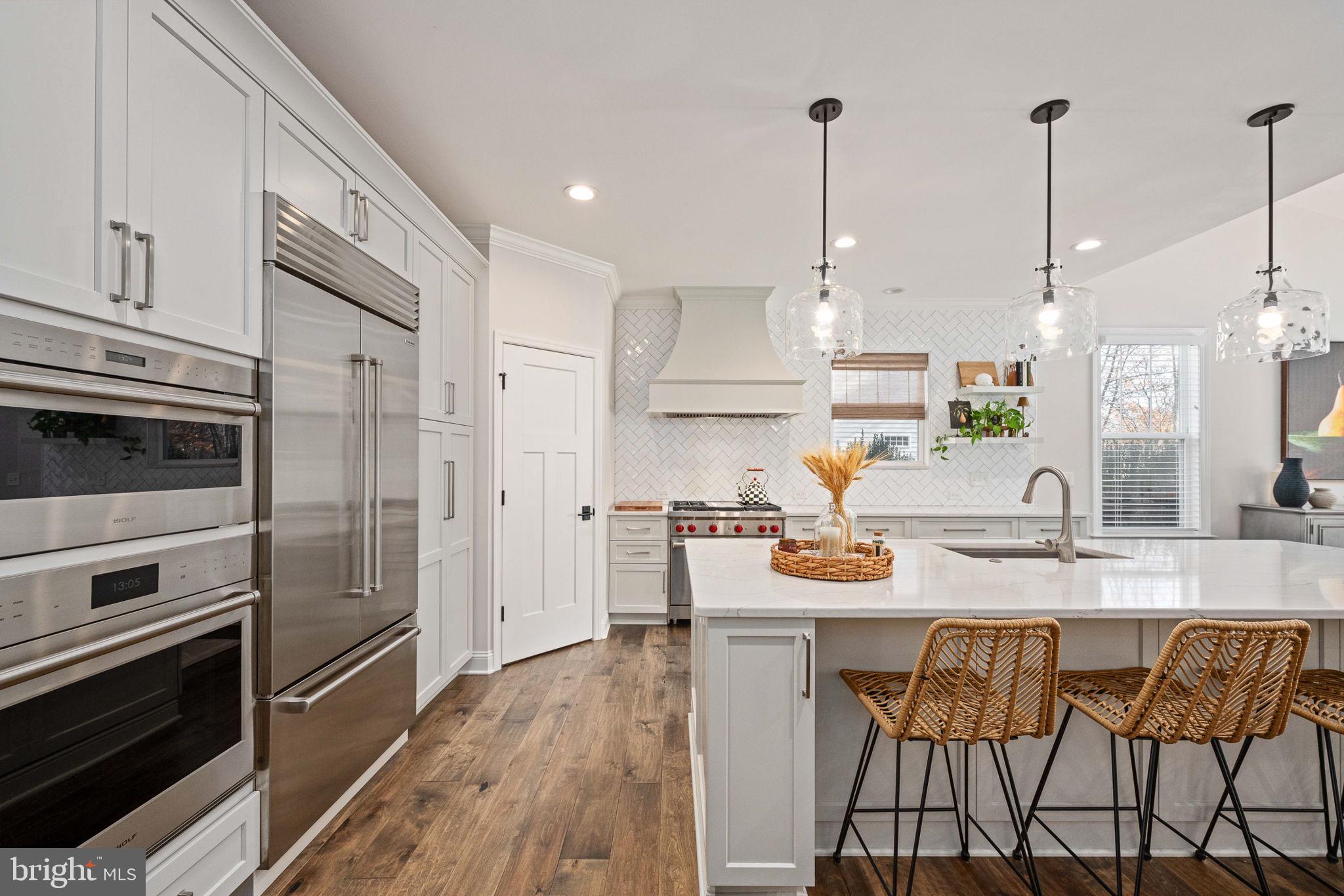 10908 Chatham Ridge Way Spotsylvania, VA 22551 - Photo 12 of 47 a kitchen with white cabinets and stainless steel appliances