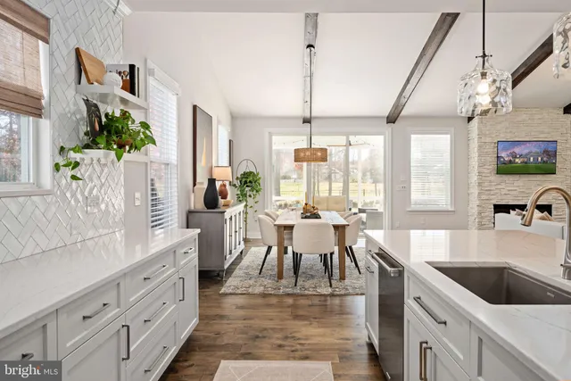 a large kitchen with a table and chairs