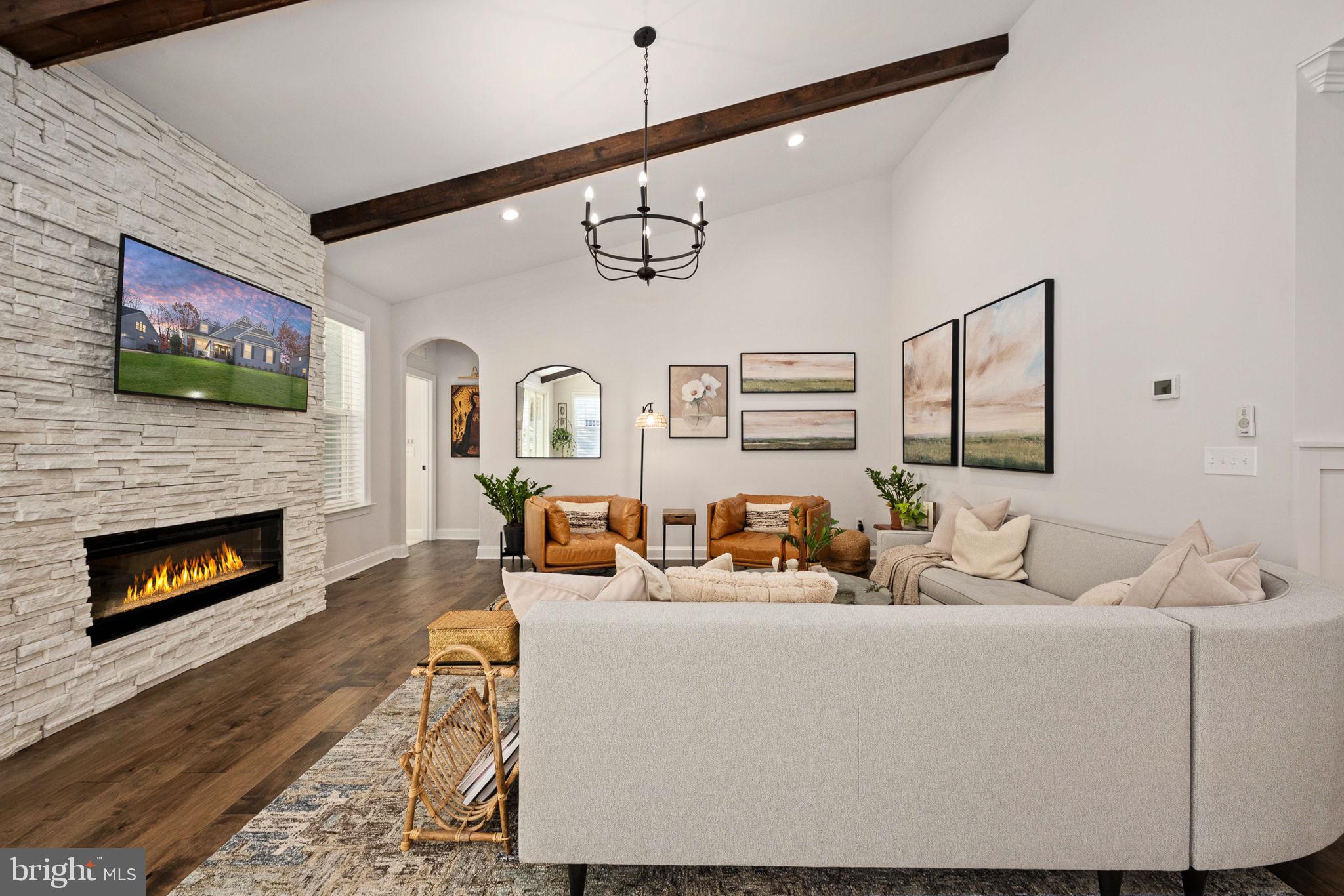 10908 Chatham Ridge Way Spotsylvania, VA 22551 - Photo 17 of 47 a living room with furniture a fireplace and a flat screen tv