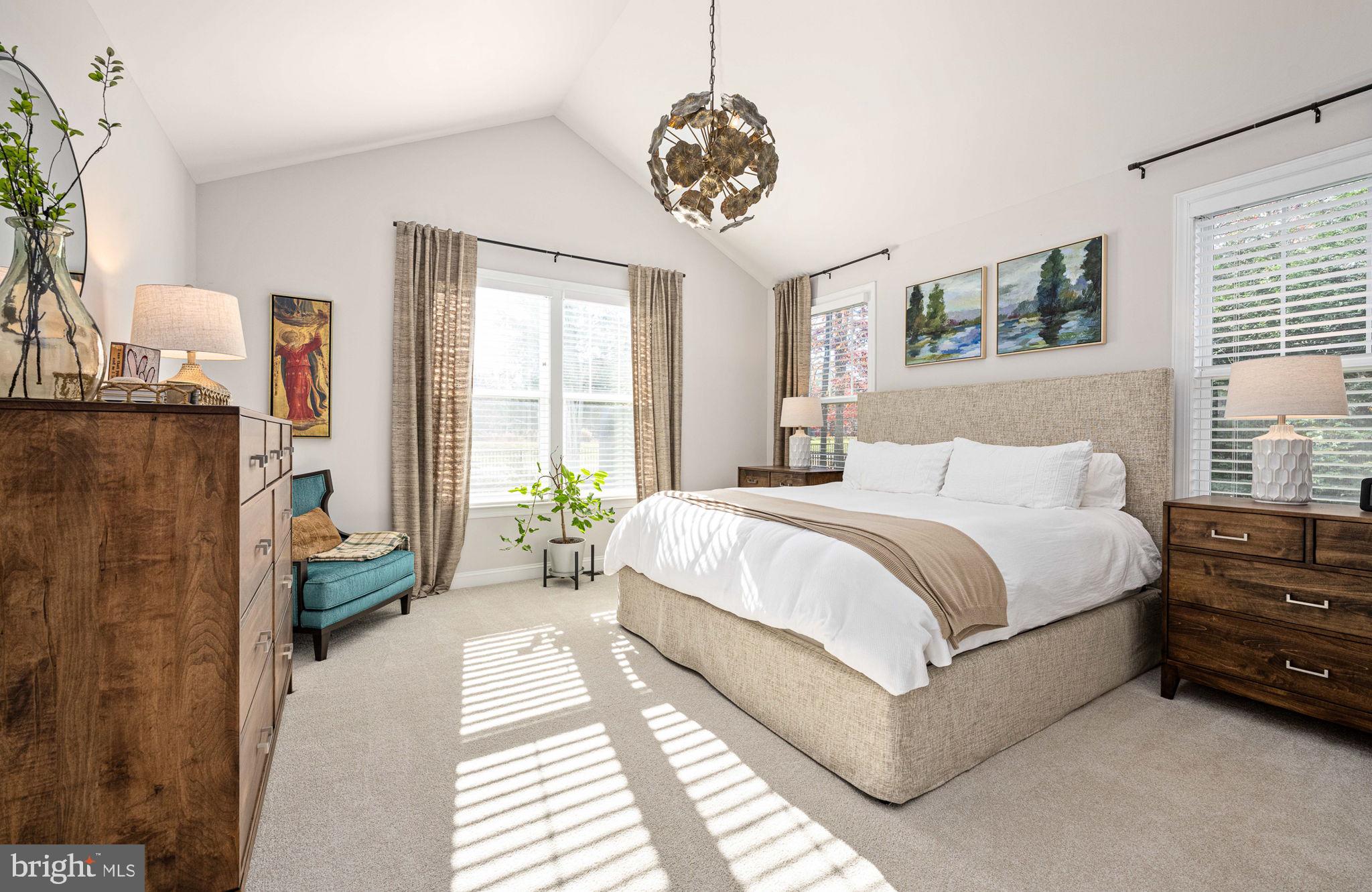 10908 Chatham Ridge Way Spotsylvania, VA 22551 - Photo 20 of 47 a spacious bedroom with a bed a dresser and windows