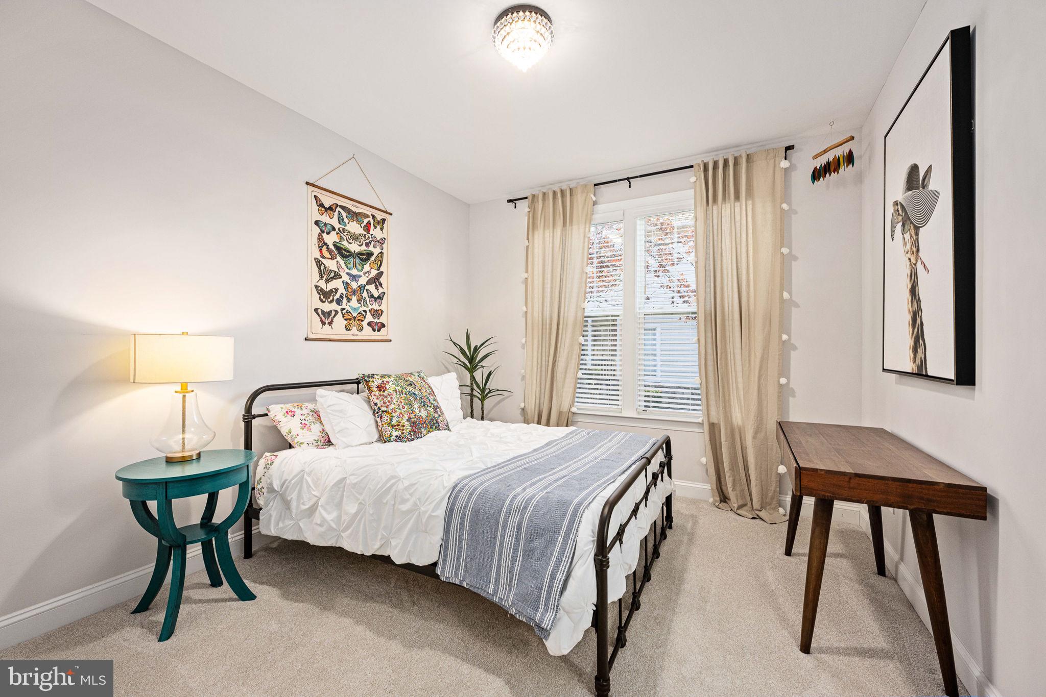 10908 Chatham Ridge Way Spotsylvania, VA 22551 - Photo 26 of 47 a bedroom with a bed and a table in it with window