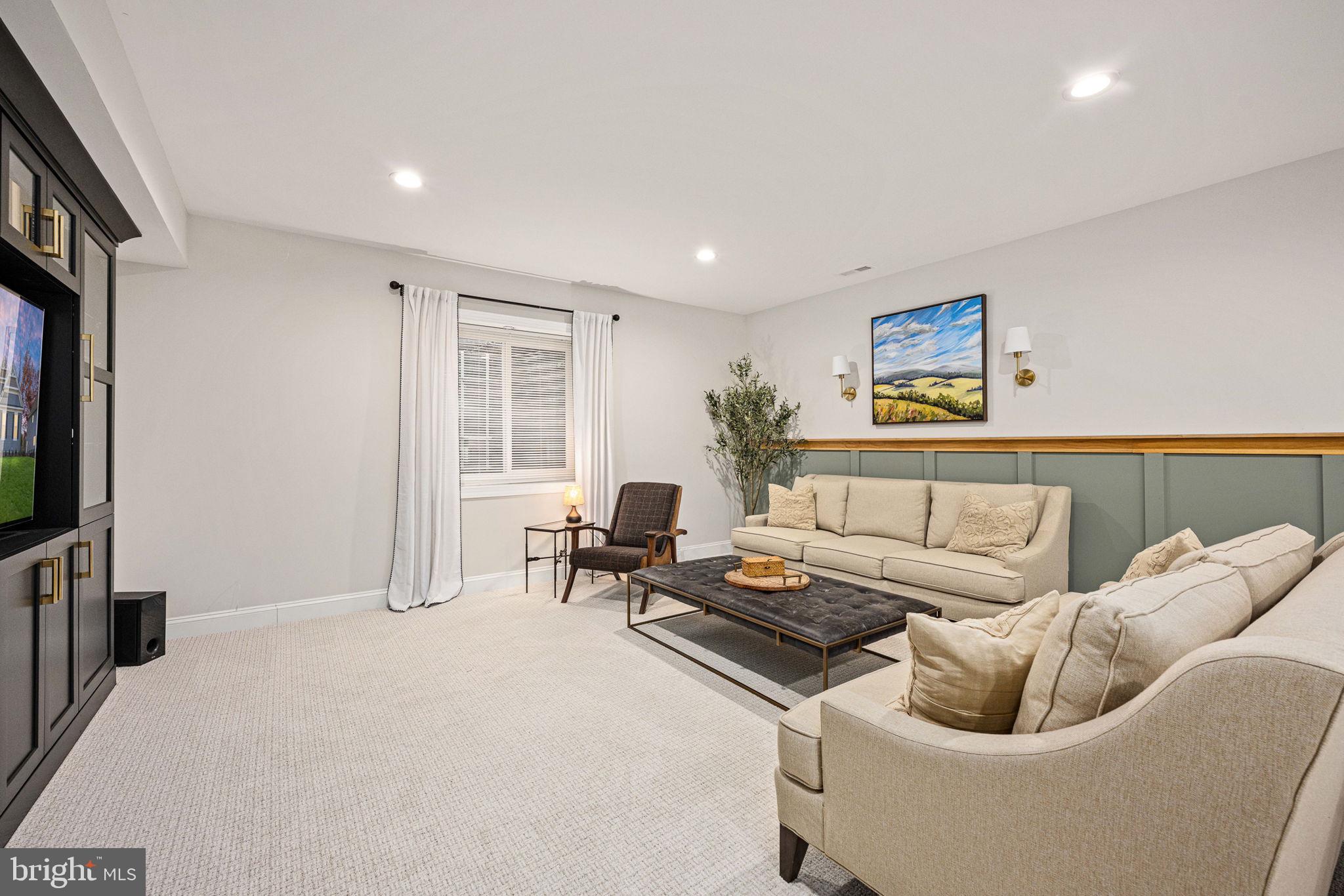 10908 Chatham Ridge Way Spotsylvania, VA 22551 - Photo 27 of 47 a living room with furniture and a flat screen tv