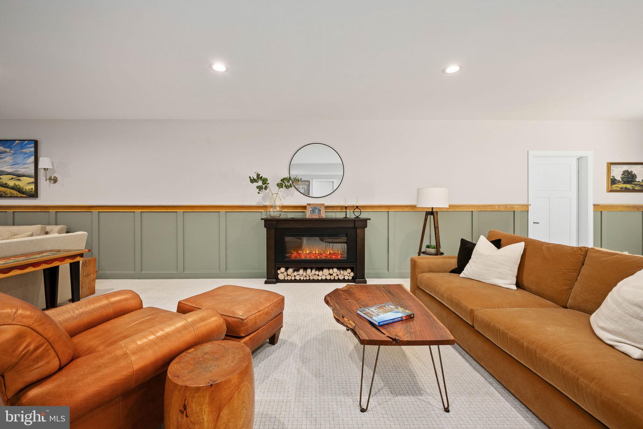 10908 Chatham Ridge Way Spotsylvania, VA 22551 - Photo 28 of 47 a living room with furniture a fireplace and a flat screen tv