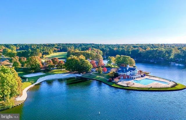 an aerial view of a swimming pool with seating space