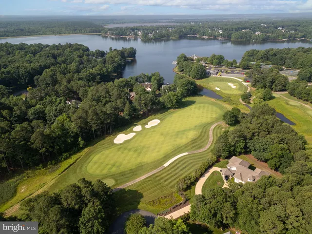 an aerial view of a residential houses with outdoor space