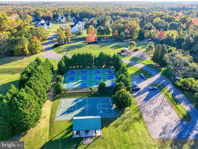 an aerial view of residential houses with outdoor space and swimming pool