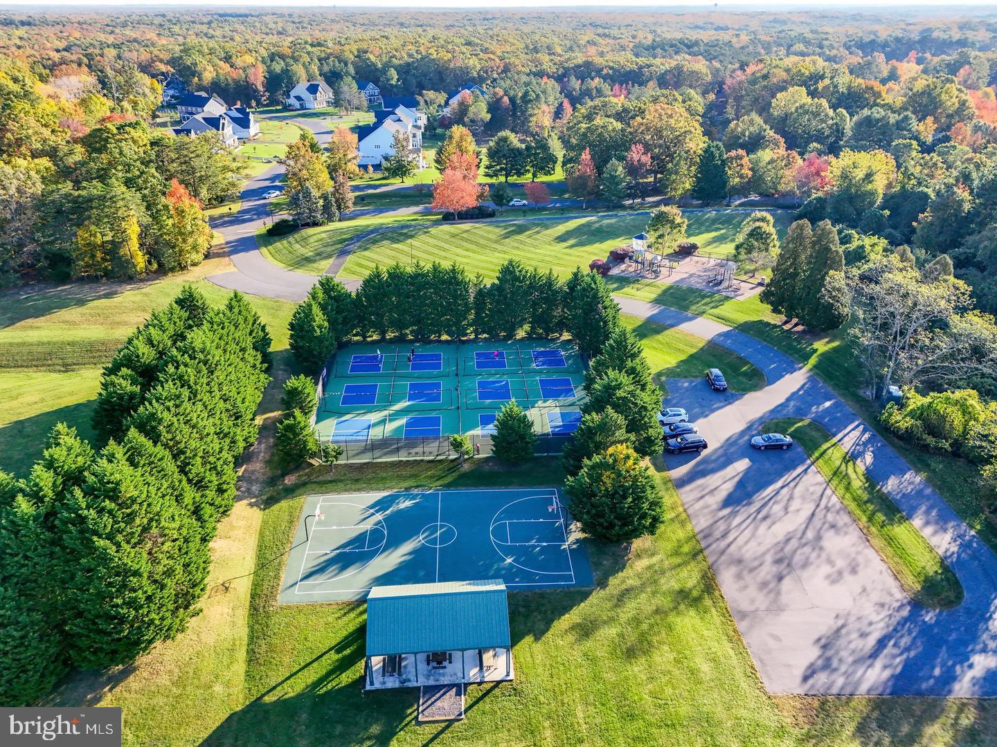 10908 Chatham Ridge Way Spotsylvania, VA 22551 - Photo 44 of 47 an aerial view of residential houses with outdoor space and swimming pool
