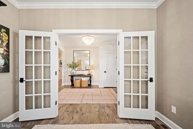 a view of a bedroom with wooden floor and a window