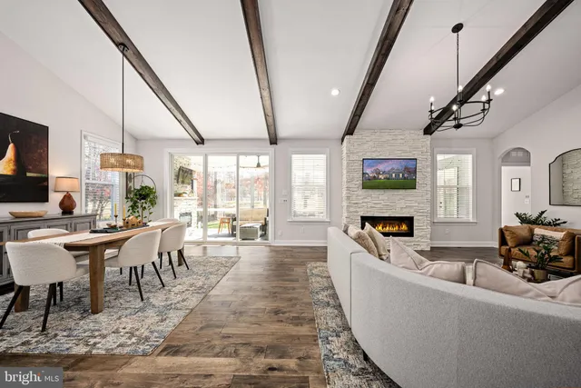 a living room with fireplace furniture and a flat screen tv