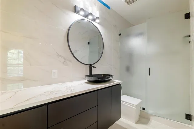 a bathroom with a double vanity sink and mirror