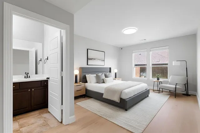 a bedroom with a bed and a large window