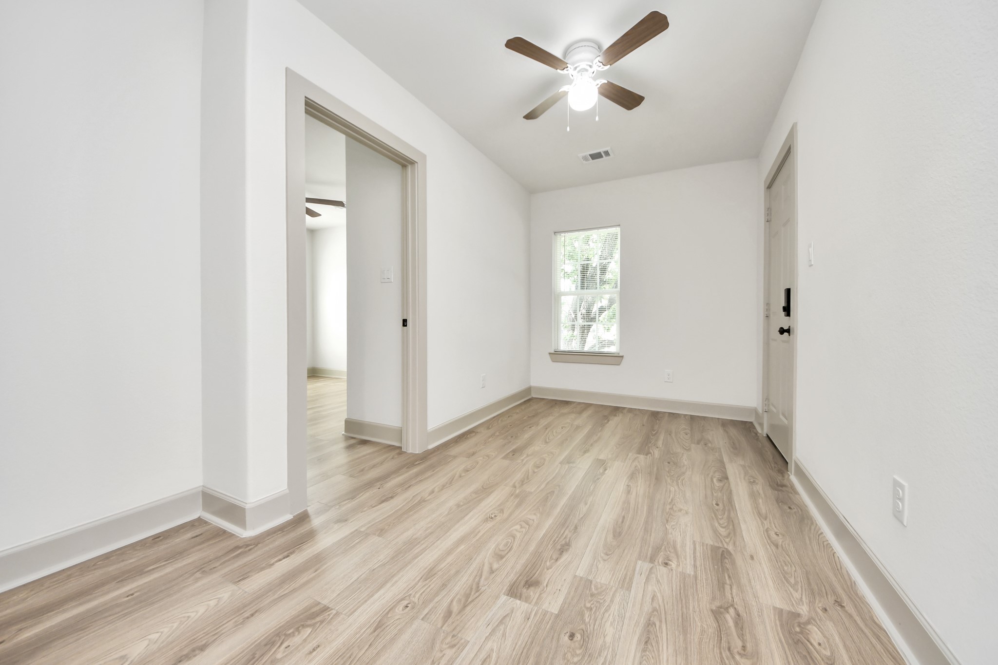 2919 Rosedale Street, Unit B Houston, TX 77004 - Photo 10 of 35 wooden floor in an empty room with a window
