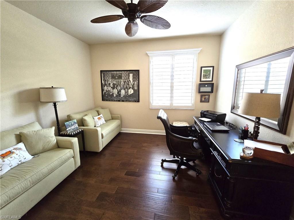 7887 Martino Circle Naples, FL 34112 - Photo 12 of 25 a view of a livingroom with workspace and a couch