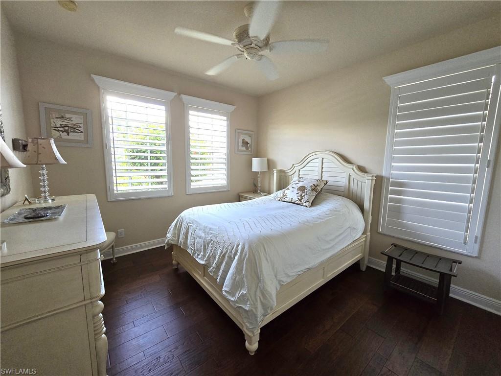 7887 Martino Circle Naples, FL 34112 - Photo 13 of 25 a bedroom with a bed and a table in it
