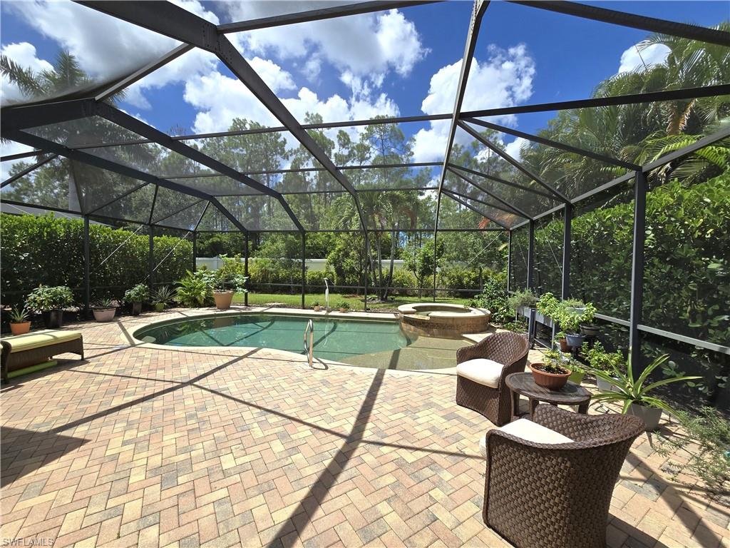 7887 Martino Circle Naples, FL 34112 - Photo 14 of 25 a view of a chairs and tables in the patio