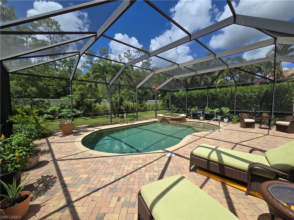 7887 Martino Circle Naples, FL 34112 - Photo 15 of 25 a view of a swimming pool with a patio