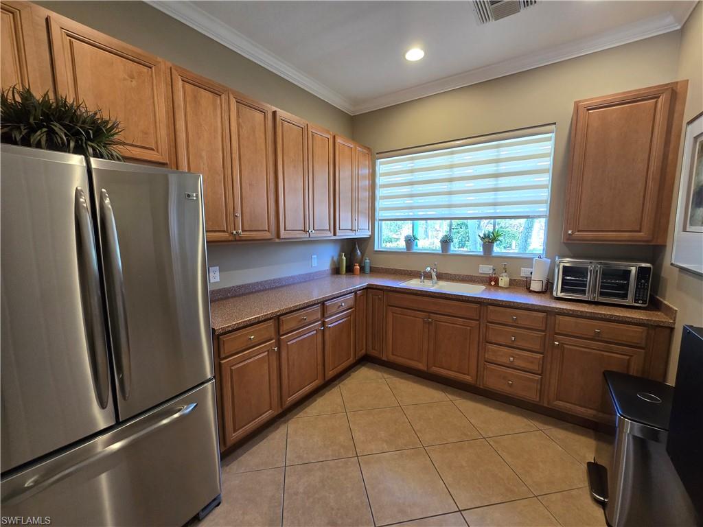 7887 Martino Circle Naples, FL 34112 - Photo 20 of 25 a kitchen with stainless steel appliances granite countertop a refrigerator and a sink