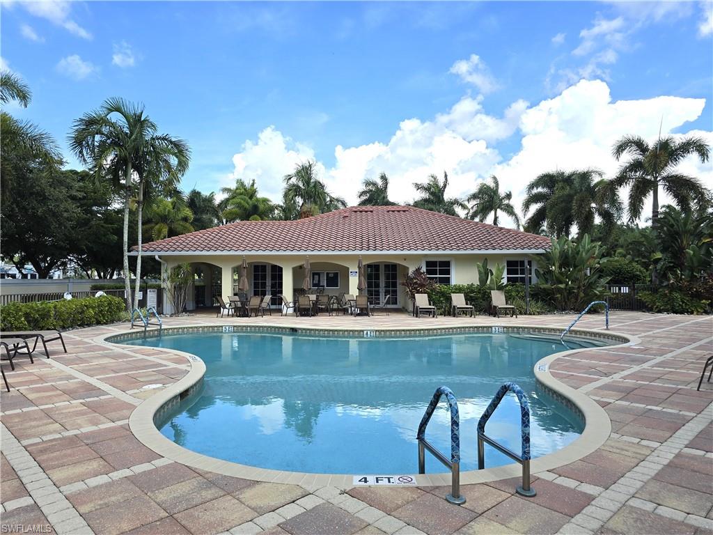 7887 Martino Circle Naples, FL 34112 - Photo 23 of 25 a view of a house with swimming pool and sitting area