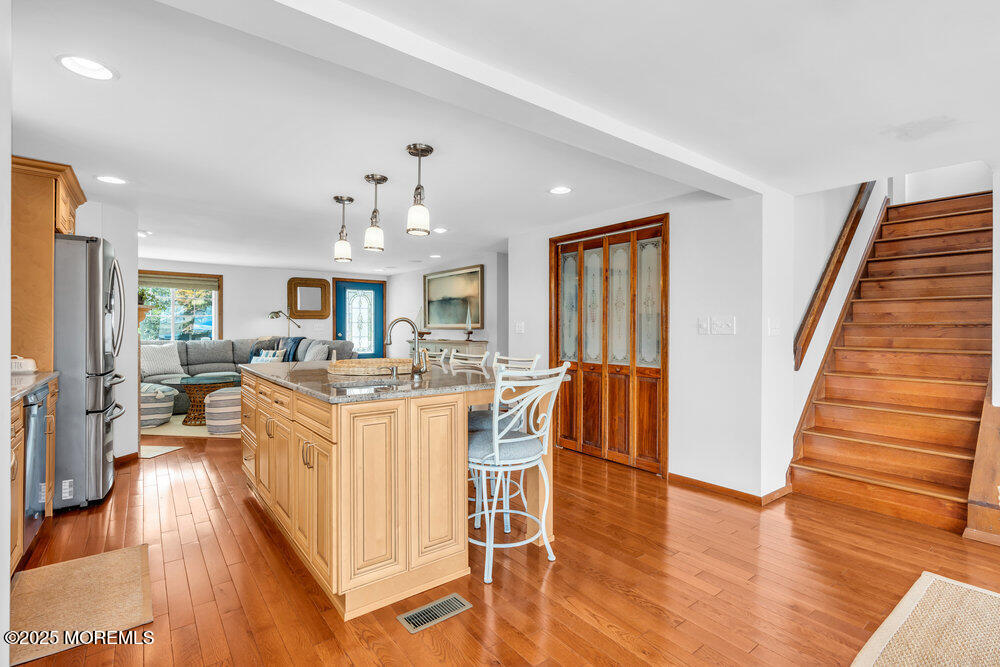 308 16th Avenue Belmar, NJ 07719 - Photo 19 of 54 a living room with furniture a dining table wooden floor and a fireplace